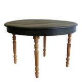 Round black dining table with oak wood.