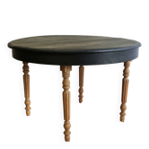 Round black dining table with oak wood.