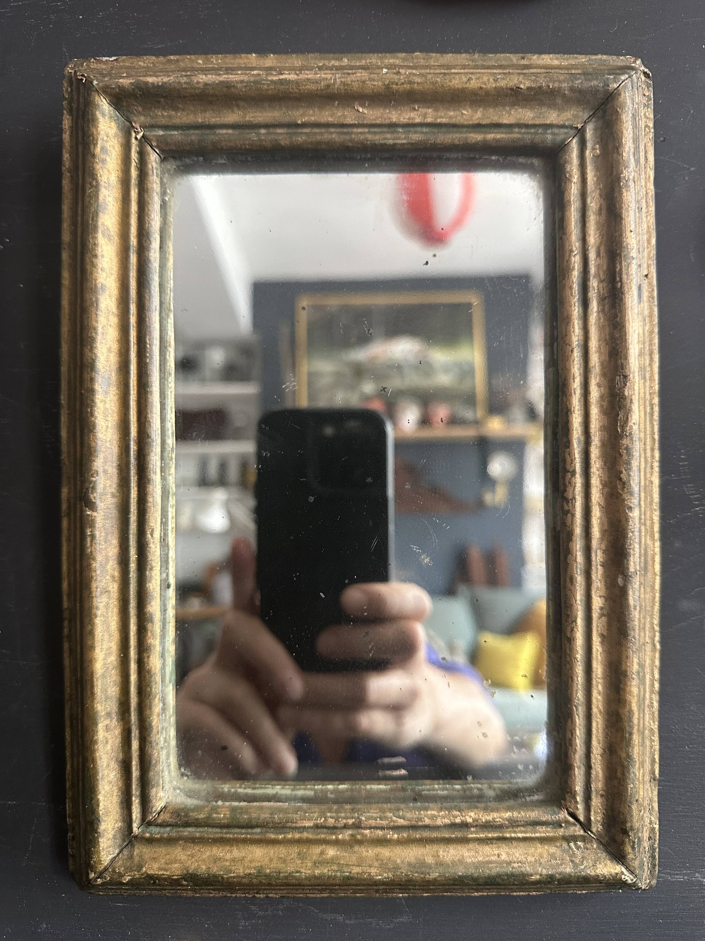 Miniature mirror from the 18th century in gilded wood, mercury glass.