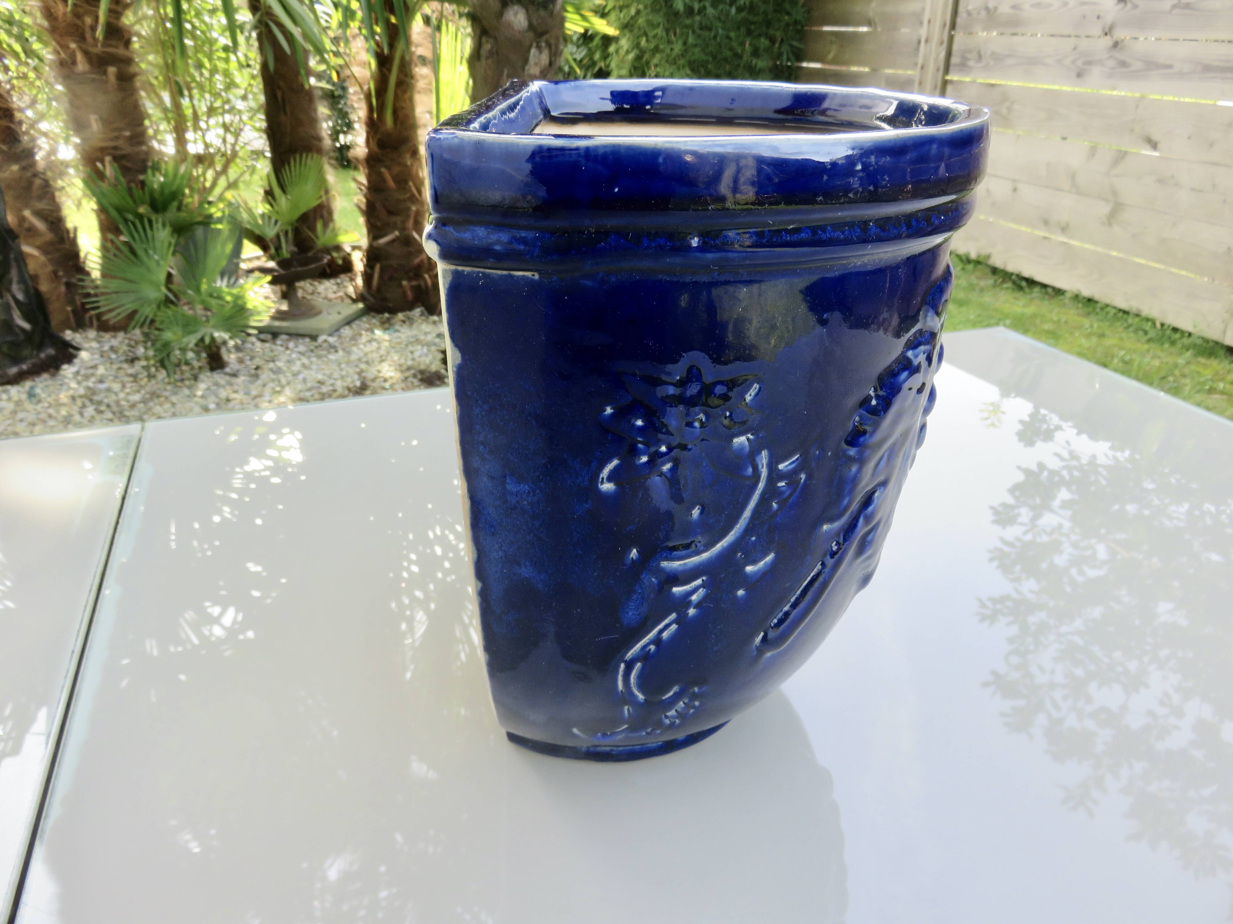 Wall pot in glazed blue terracotta with a grape motif, 1970s.