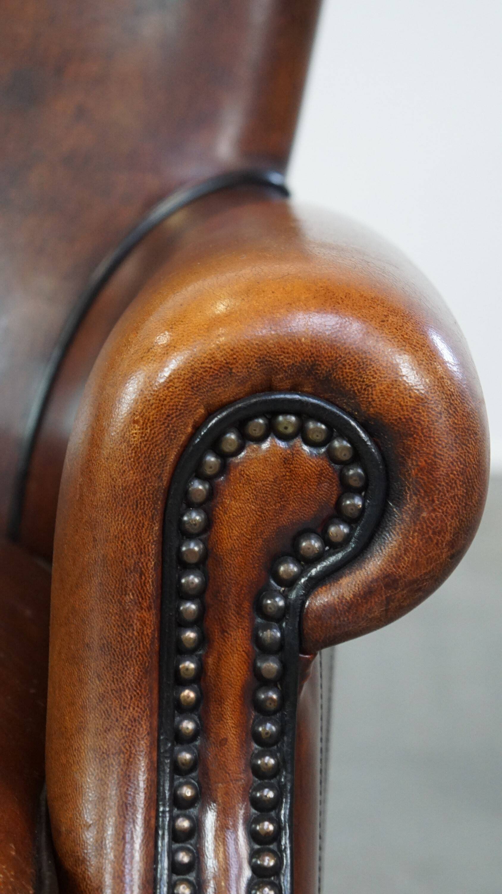 Sheepskin armchair/lounge chair finished with decorative nailheads