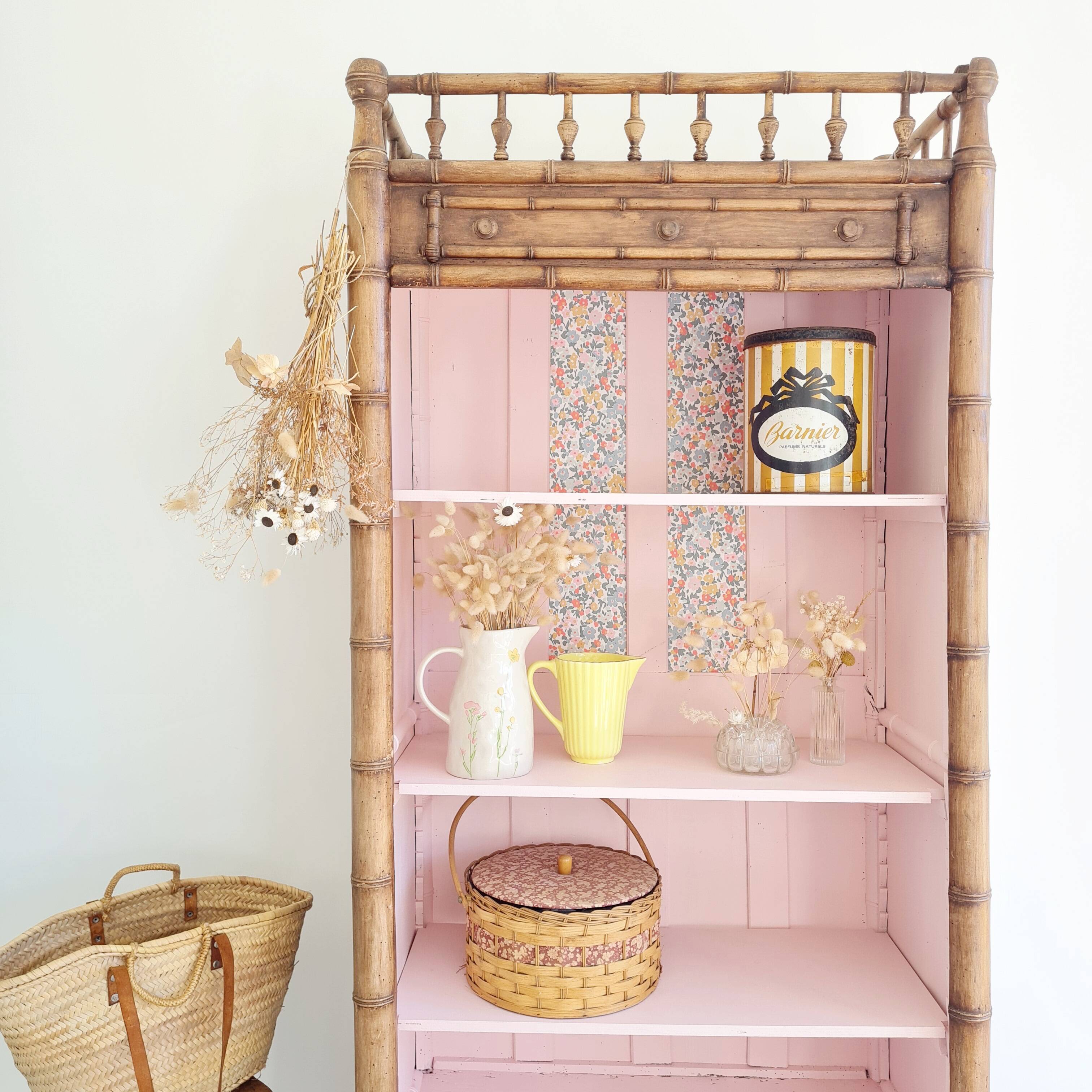 Library, old wooden cabinet imitating bamboo painted in pink