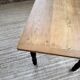 Oak farmhouse table with turned black legs.