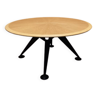 Round wooden and metal quadripod dining table