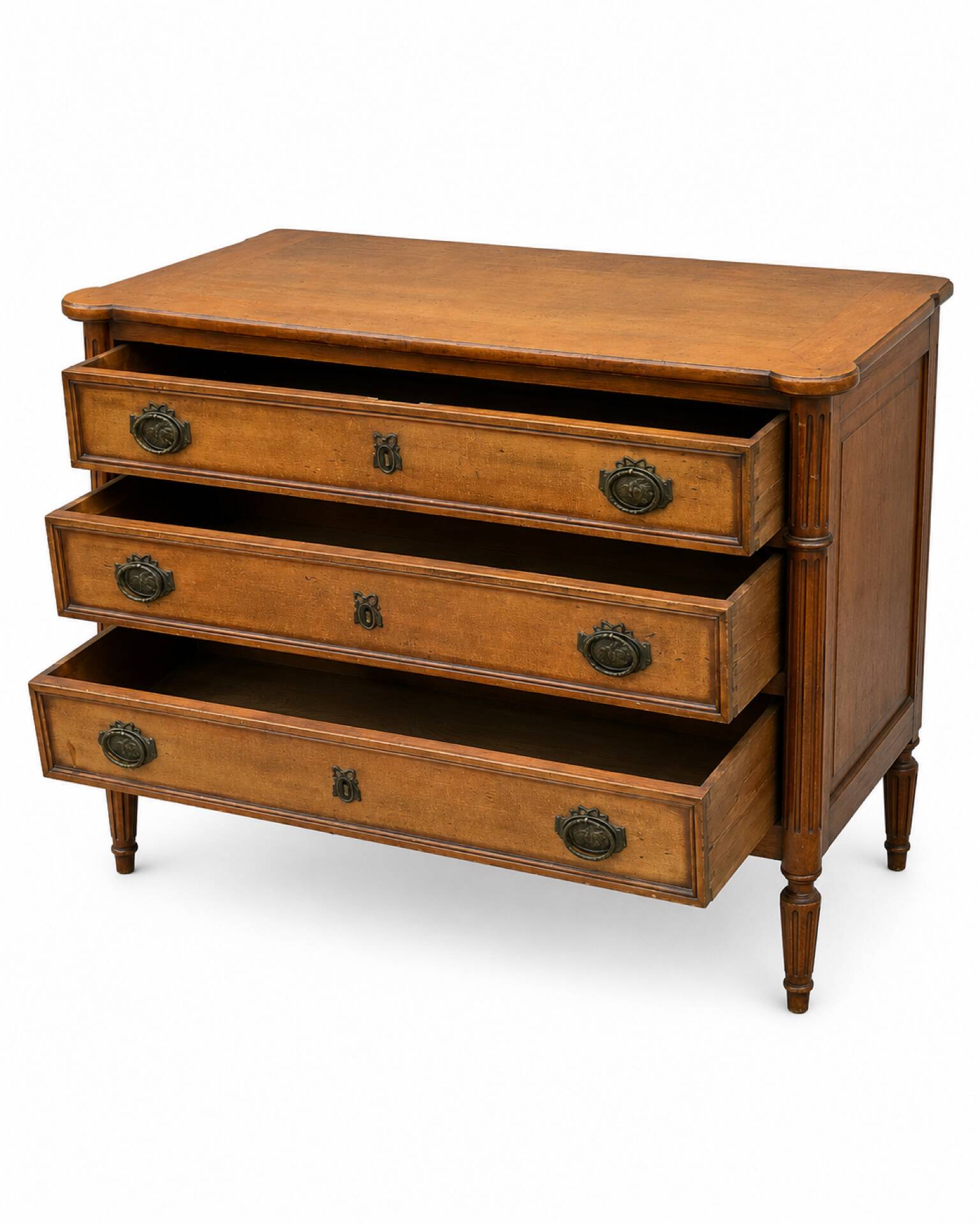 Light walnut commode in Louis XVI style with fluted motifs and three drawers.