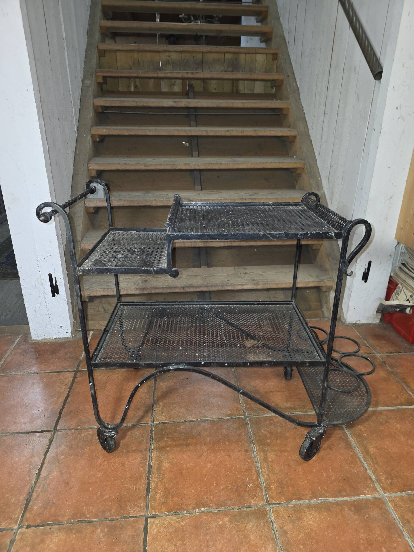 Perforated wrought iron rolling dessert trolley