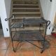Perforated wrought iron rolling dessert trolley