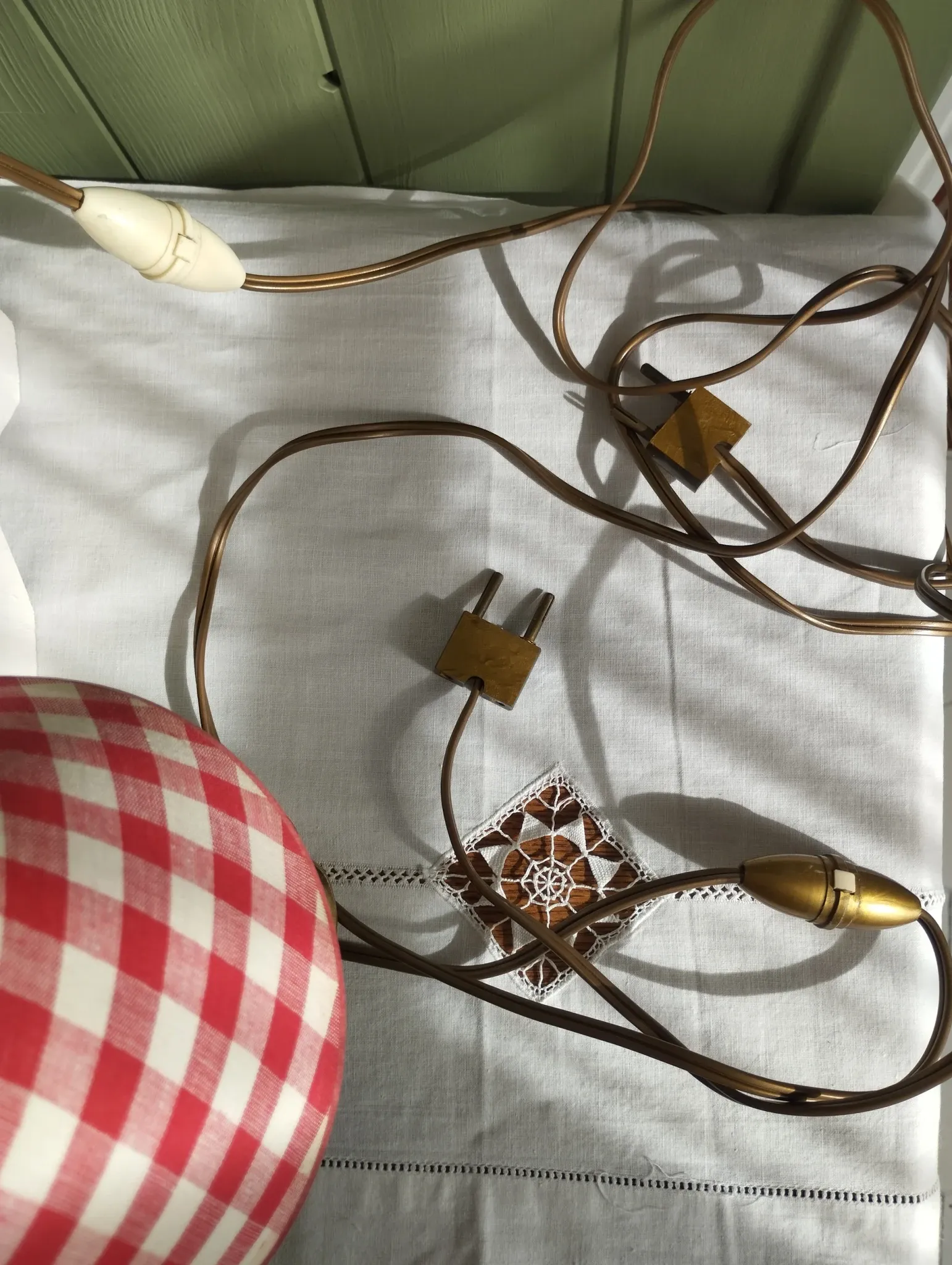 Pair of small lamps in gilded bronze by Petitot and red gingham lampshades.