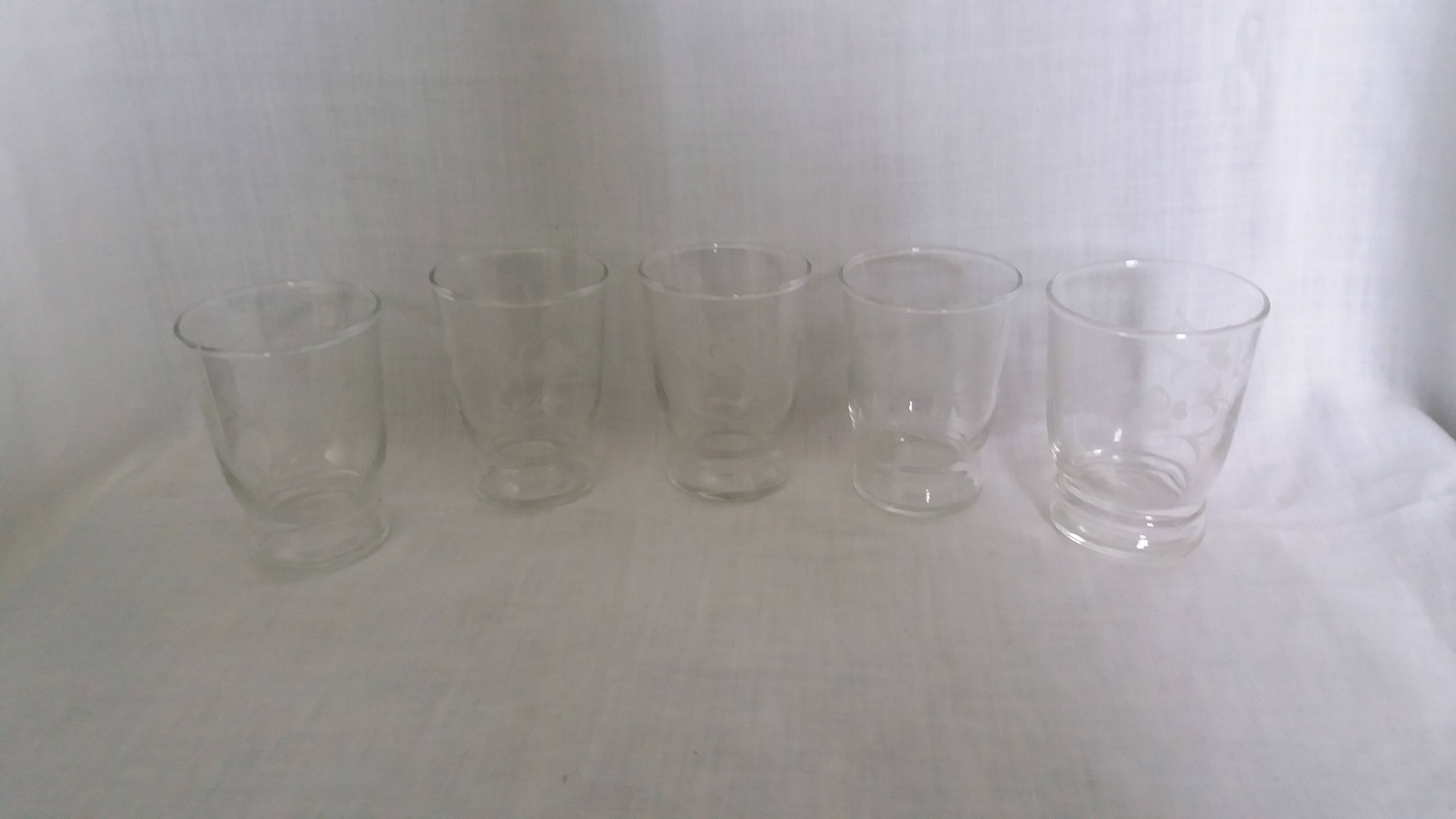 Old digestif or liqueur glasses, handcrafted glass with a floral pattern.