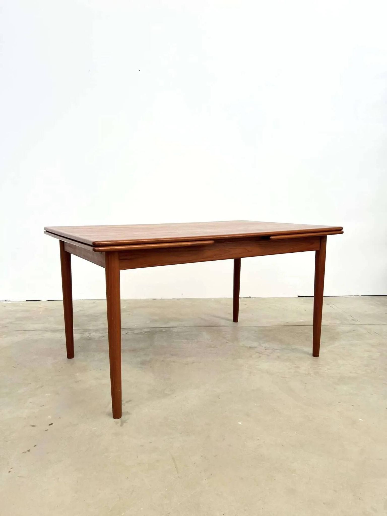 Teak dining table with integrated extensions — Scandinavian