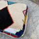Berber floor pouf: Handwoven Moroccan wool cushion.