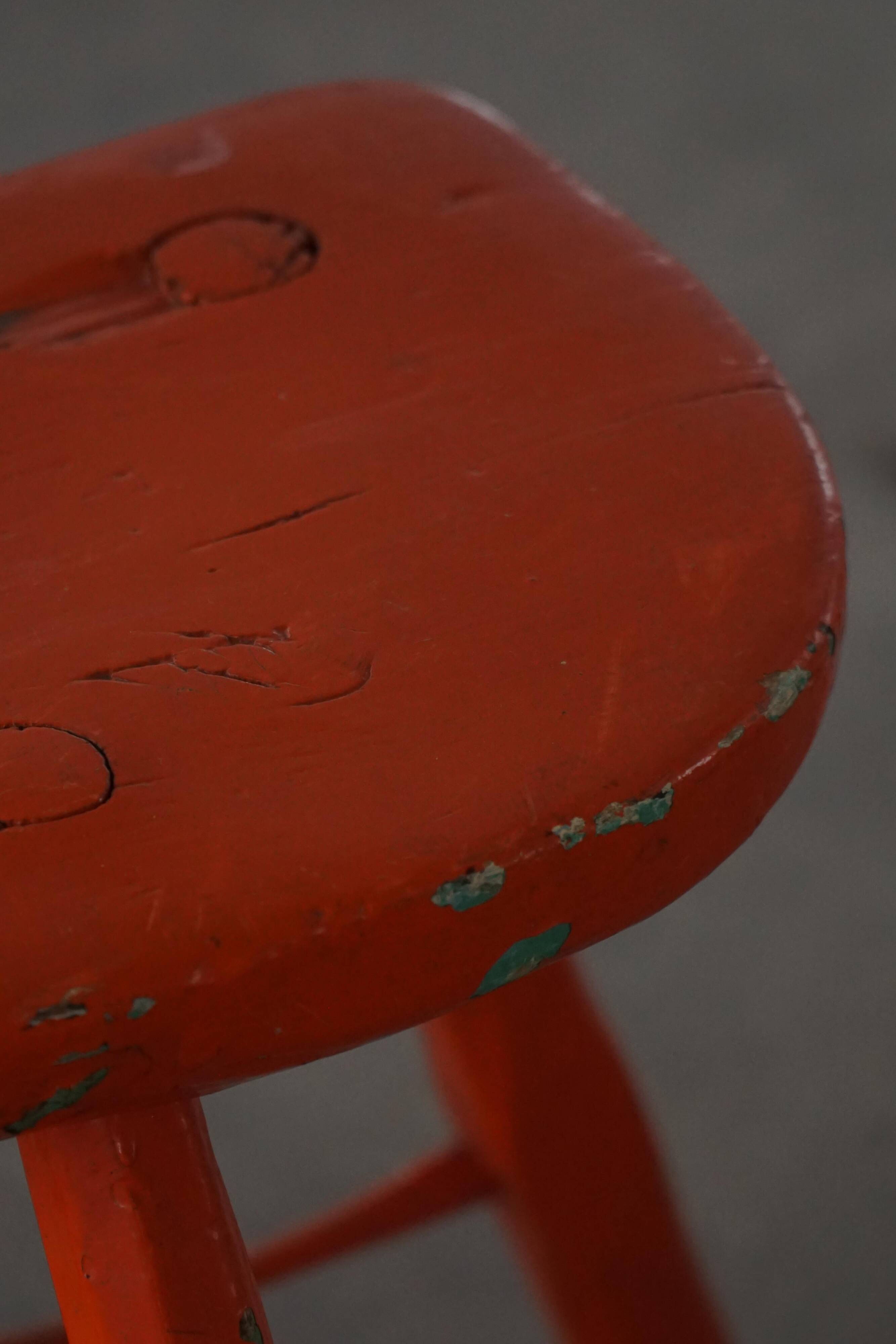 Pair of patinated wooden stools painted red with flared legs, 1950s-1960s.