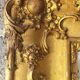 Antique Louis Philippe style gilded mirror decorated with floral motifs