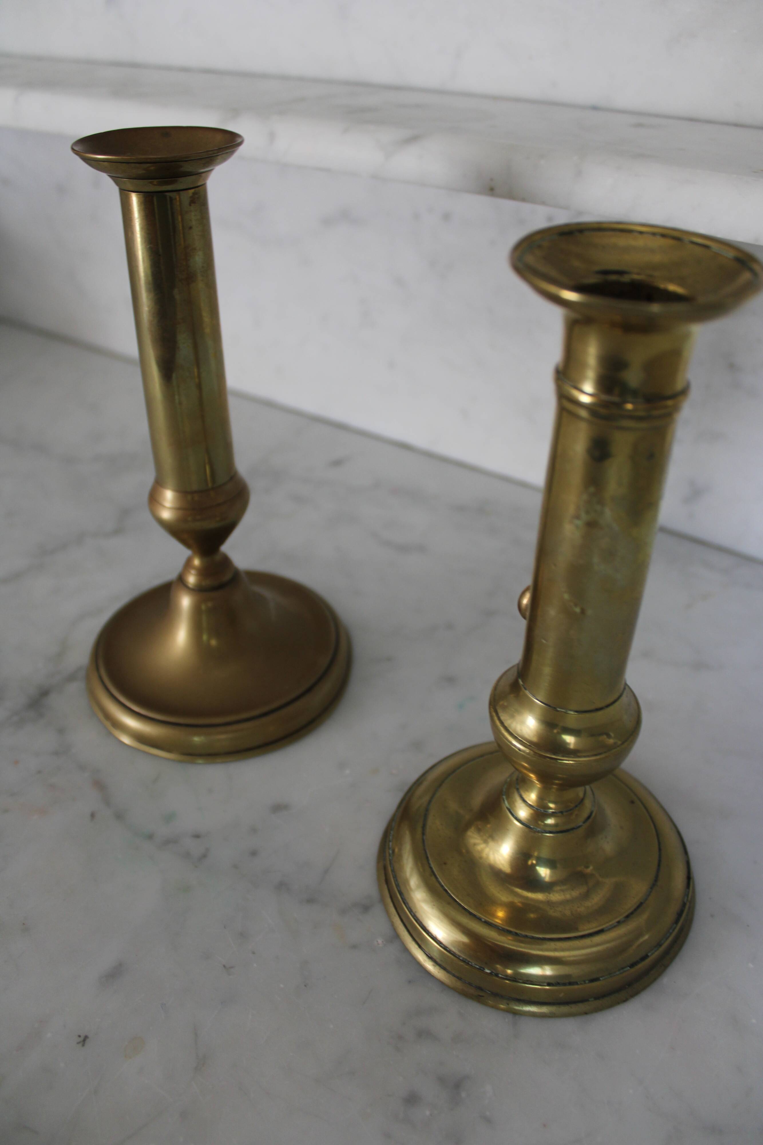 Pair of brass pusher candlesticks