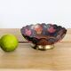 Vintage brass bowl with peacock motif, painted enamel, scalloped edge on a pedestal.