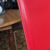 Red leather dining chairs by Arper