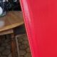 Red leather dining chairs by Arper