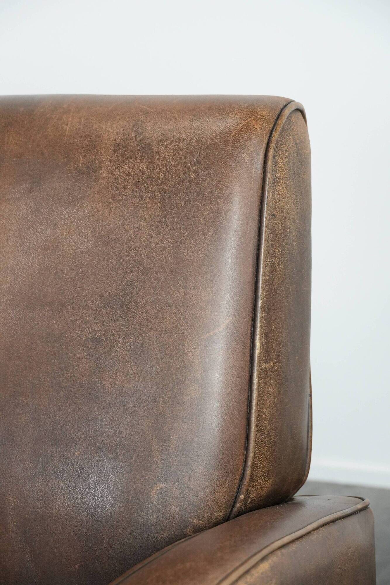 Elegant set of two sheepskin leather armchairs with beautiful round shapes