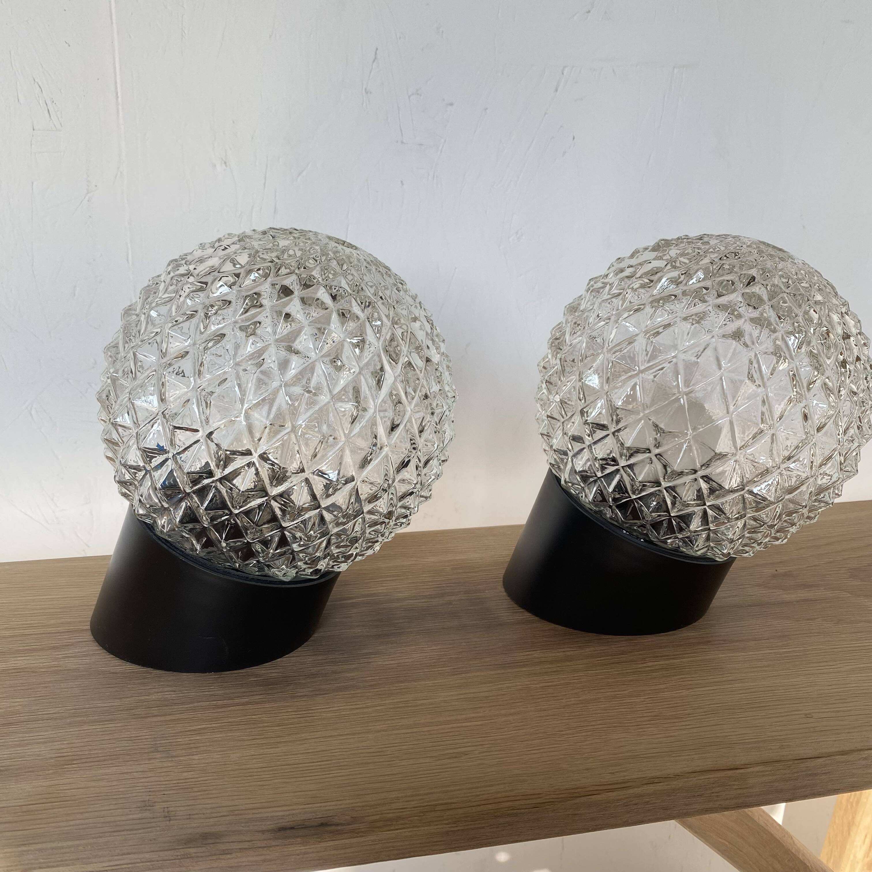 Pair of slanted glass wall lights with black plastic base, decorative v