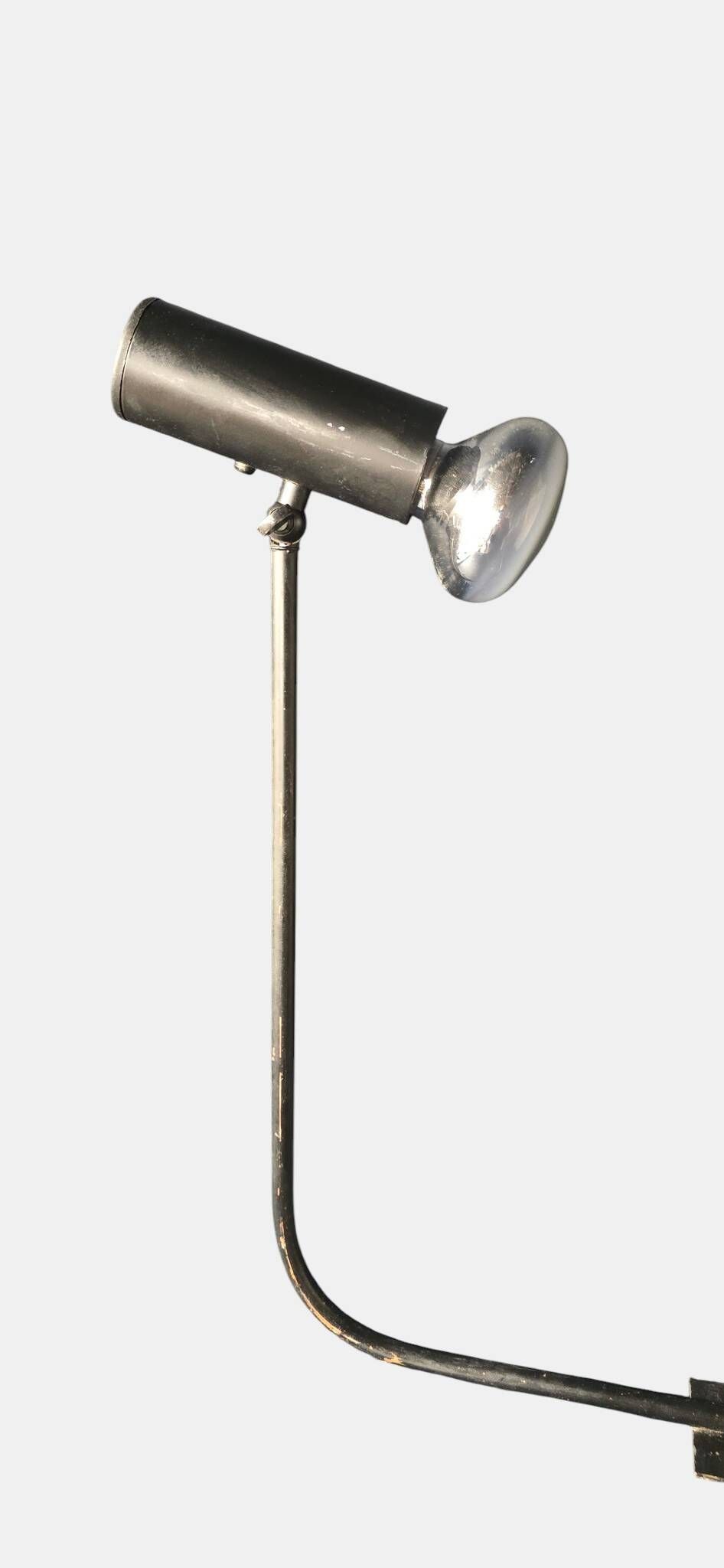 Minimalist metal wall light in the style of Jean Prouvé, circa 1950.