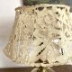 Antique brass lamp with embroidered openwork shade.