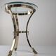 Neoclassical side table in brass and bevelled glass with ram's heads, 1970s.