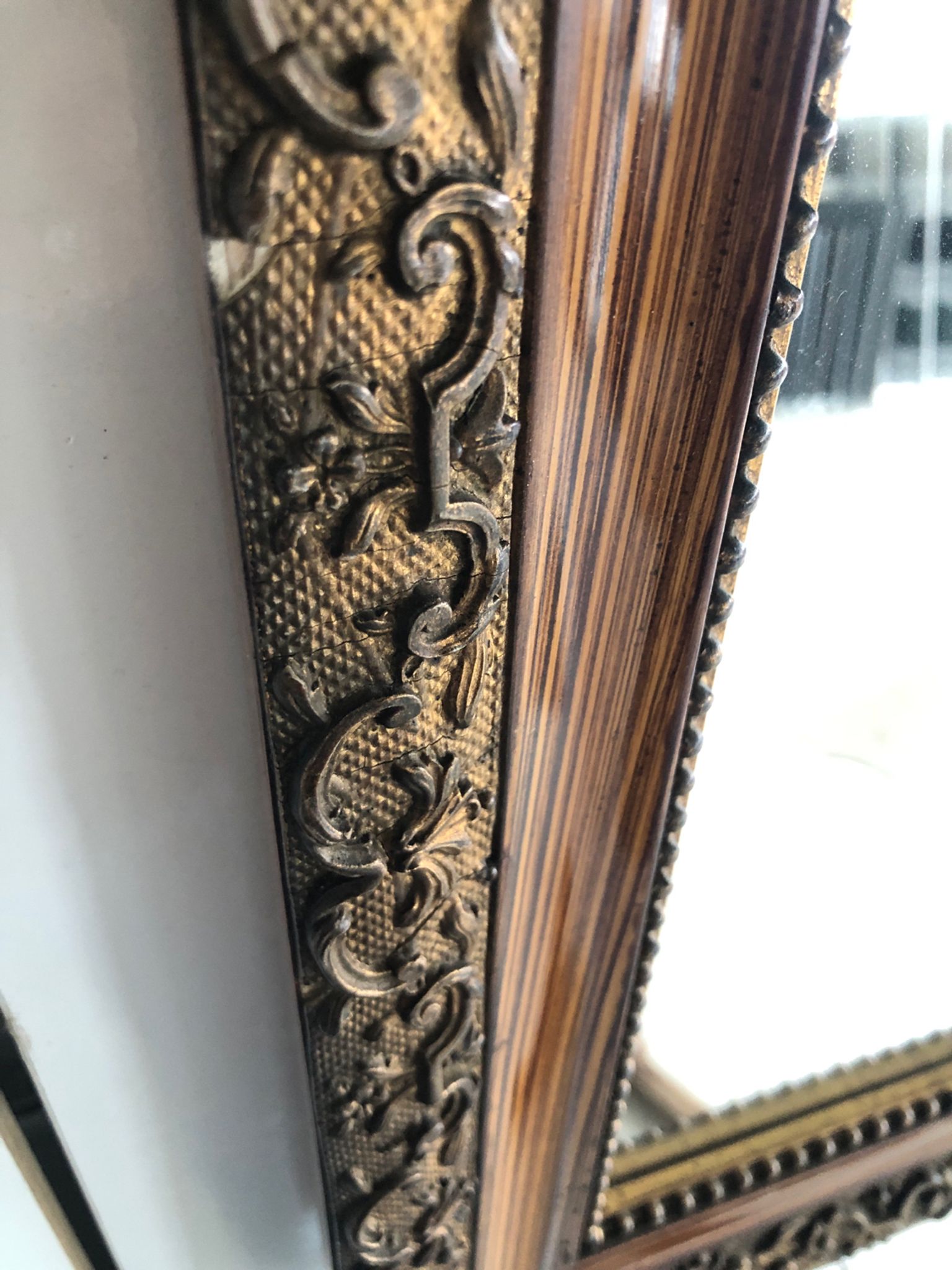 Old mirror with wooden frame and plaster moldings