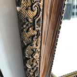 Old mirror with wooden frame and plaster moldings