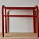 Vintage side table in red tubular steel - smoked glass window - 1980s