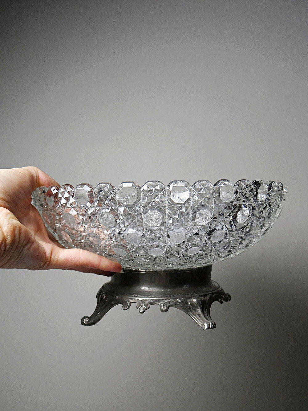 Pressed glass coupe with diamond points, antique from 1920-1950 on a pewter base.