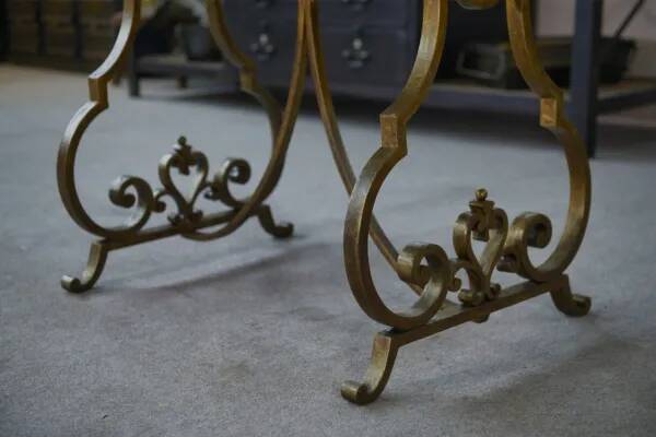 Side table with a gilt wrought iron base attributed to Gilbert Poillerat, with a travertine top, 1940s