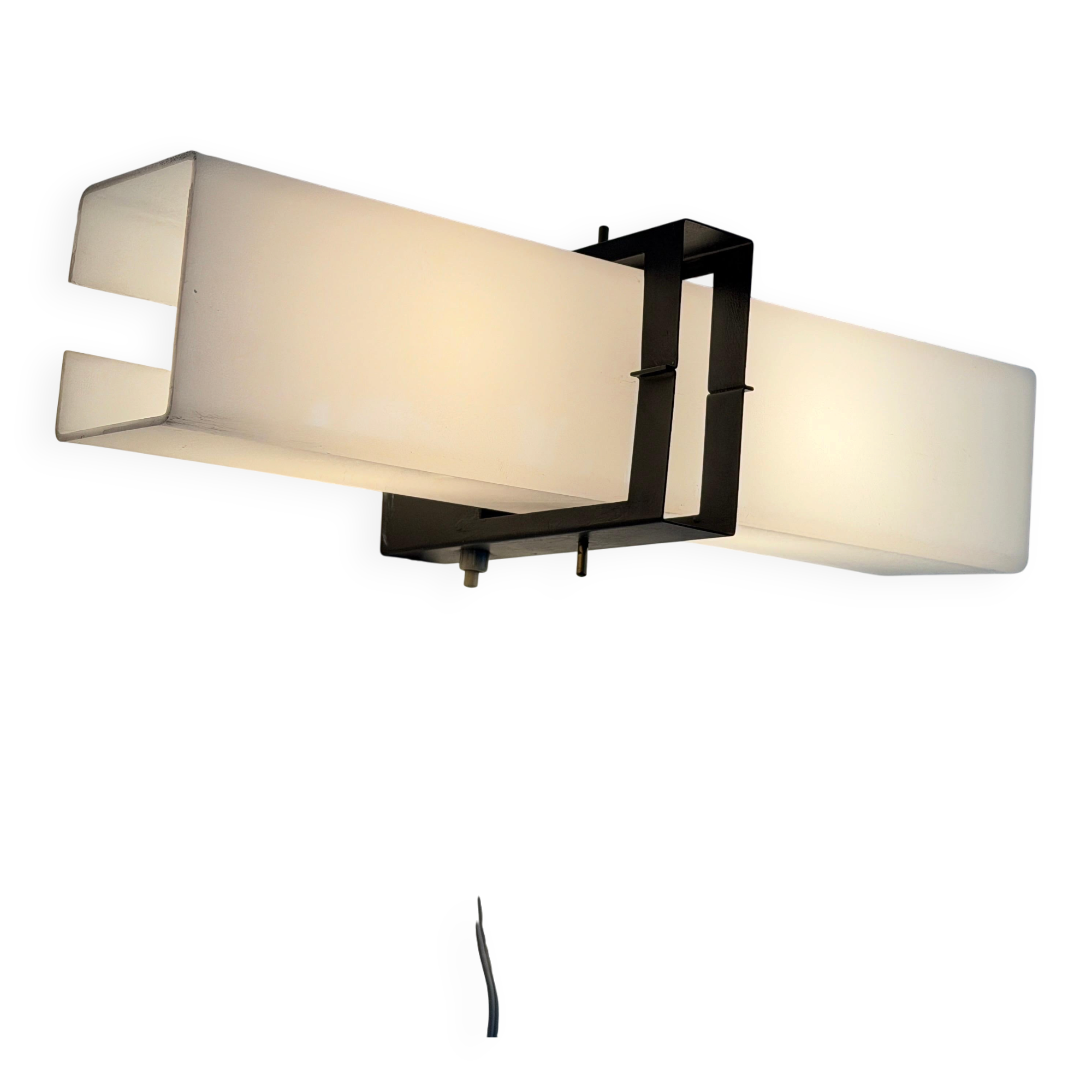 Simple white plexiglass wall light with a black metal frame, 1970s, Germany.