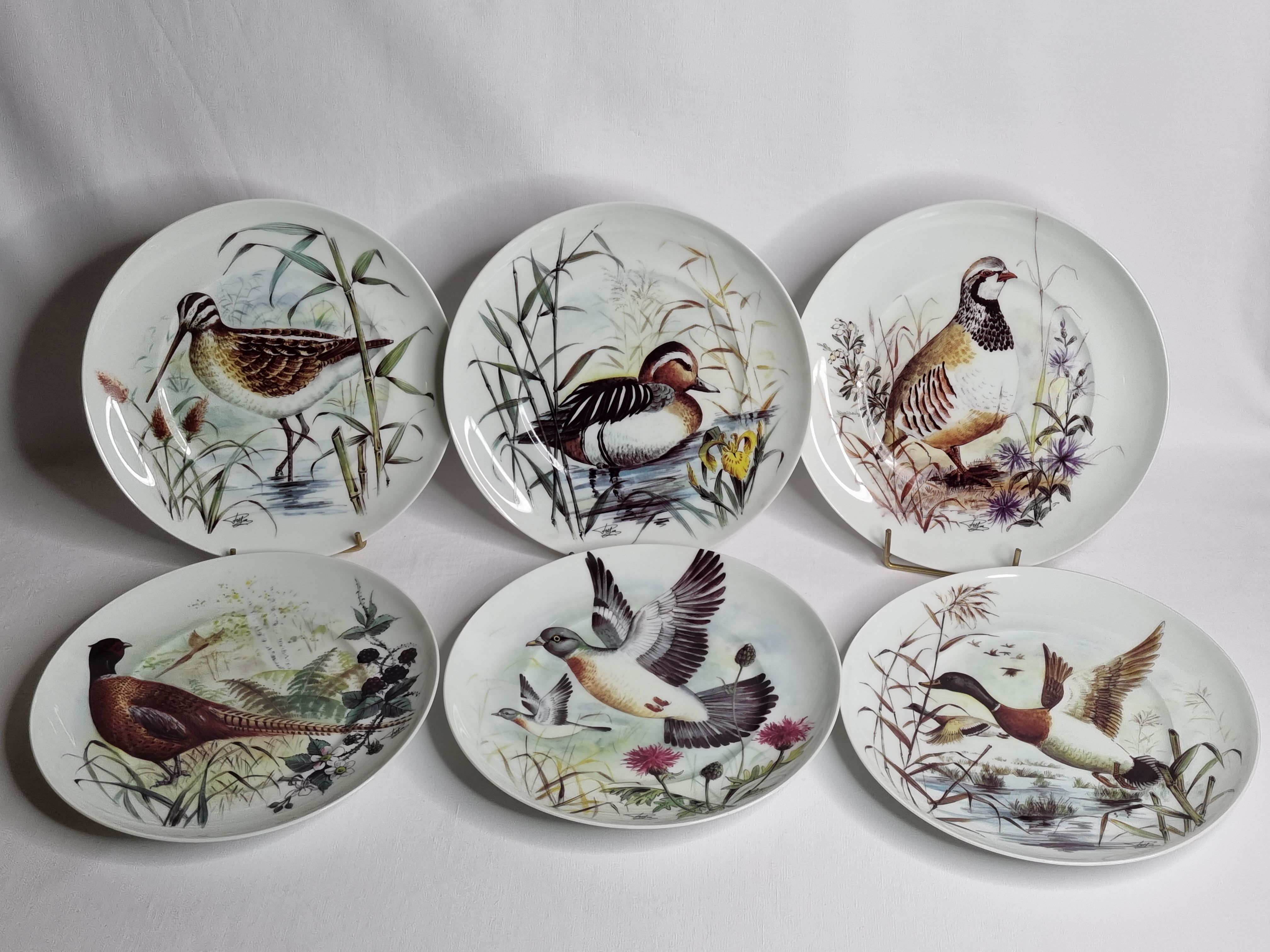 Set of six porcelain plates decorated with birds from Sologne, Limoges, signed, 25 cm