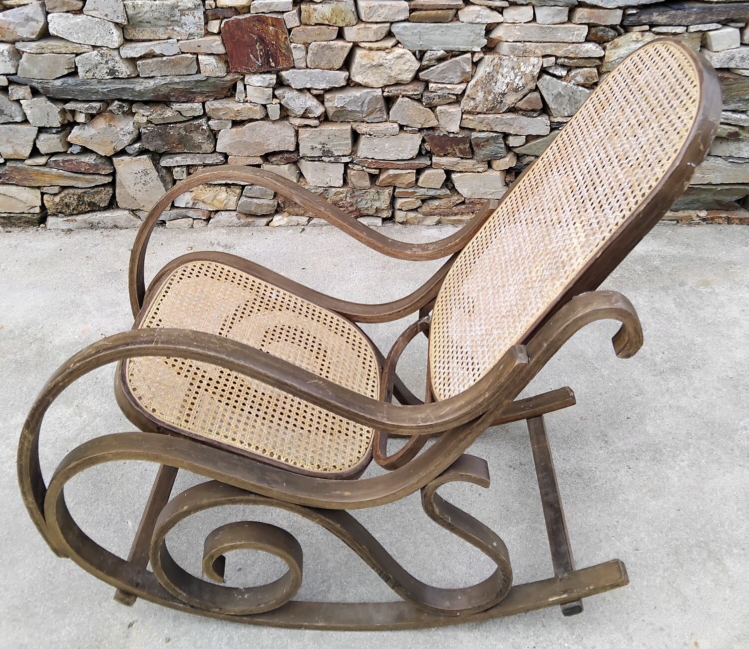 Vintage wooden and cane rocking chair