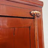 Antique red cabinet with brass details