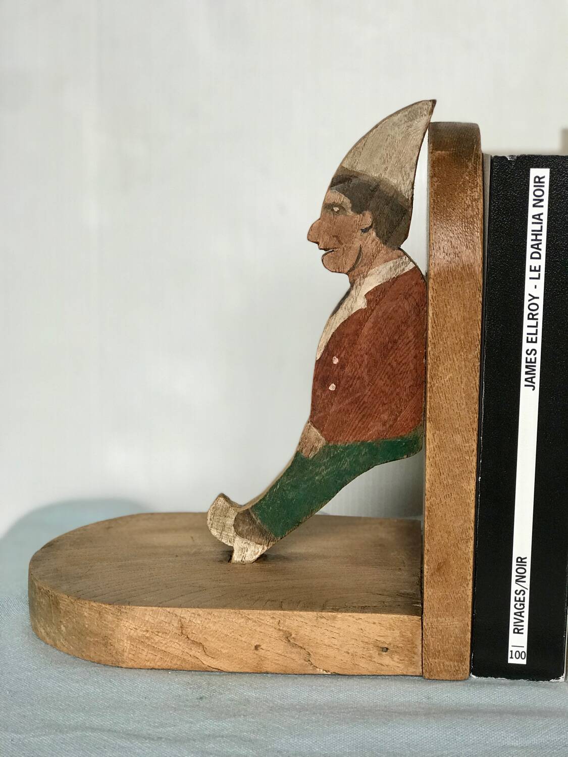 Old wooden bookends with painted characters
