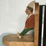 Old wooden bookends with painted characters