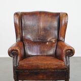 Cognac-colored vintage sheep leather wingback chair with character