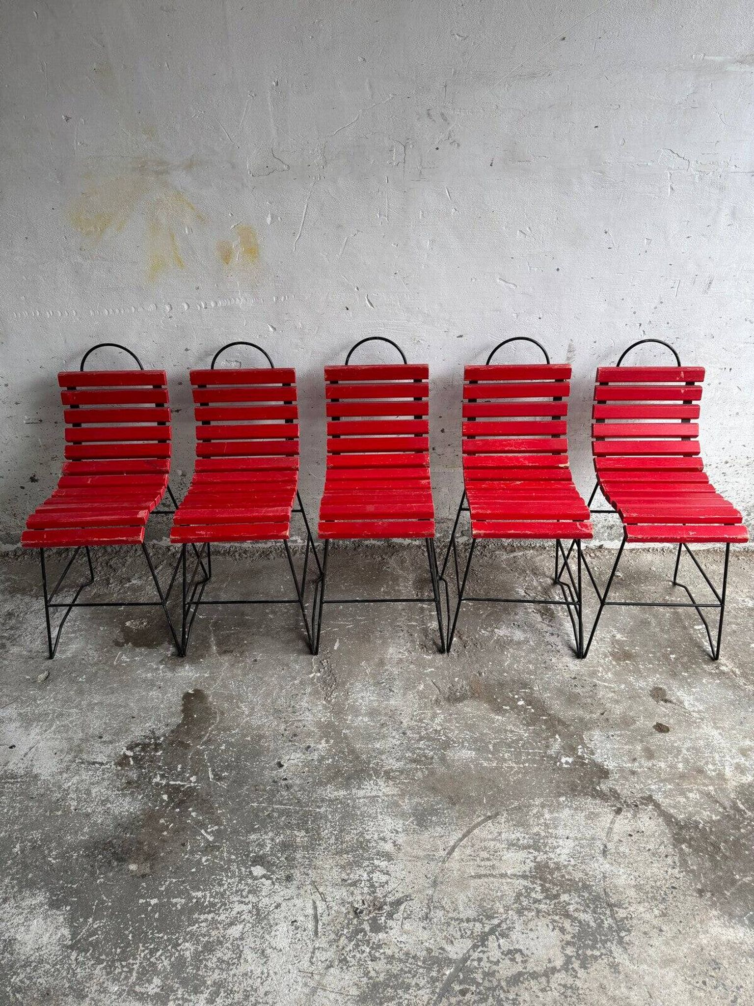 Red slatted chair with a black metal frame.