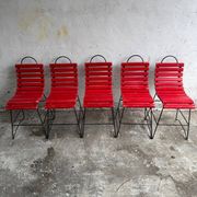 Red slatted chair with a black metal frame.