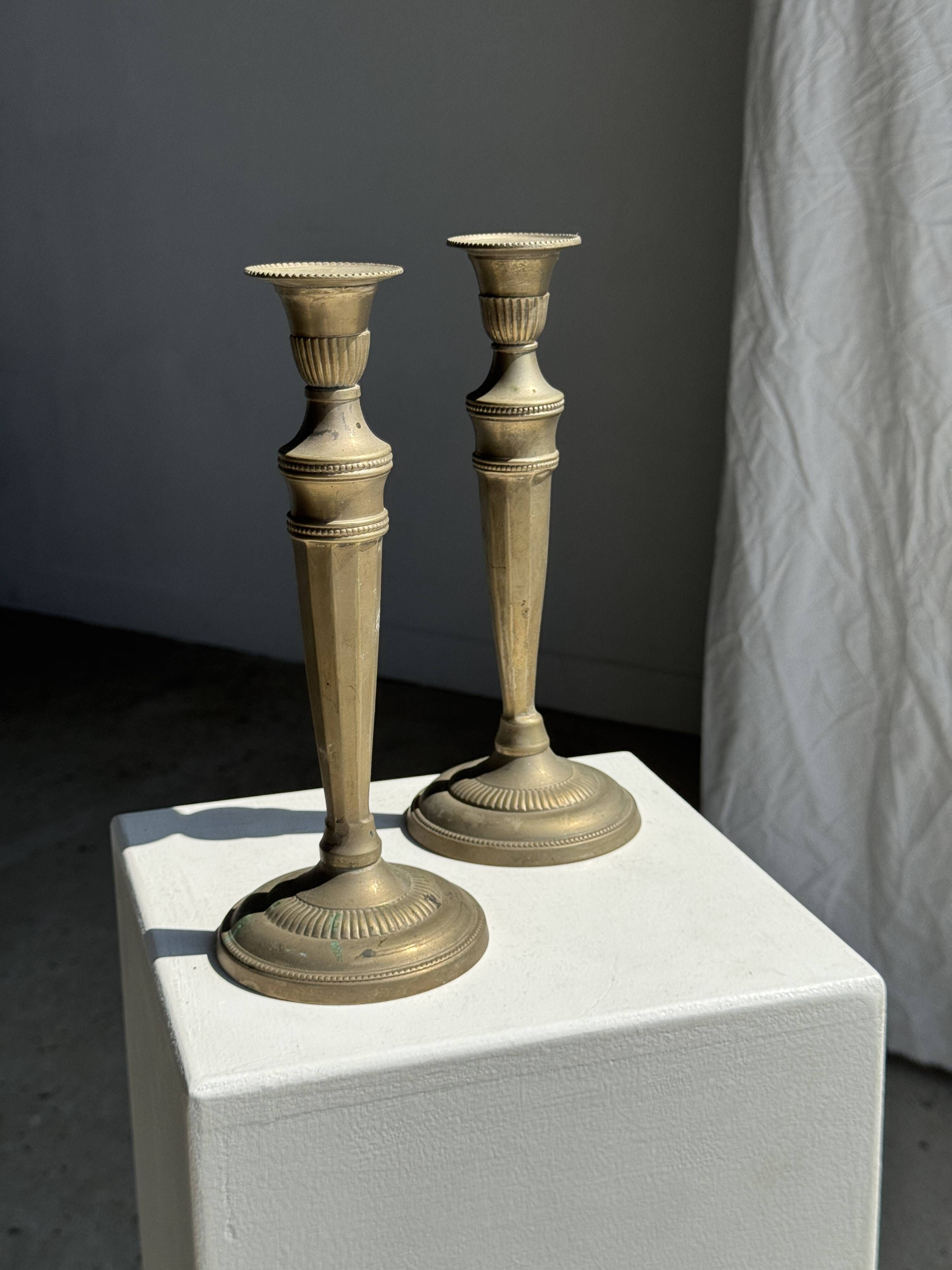 Pair of classic candlesticks in patinated gold metal H25