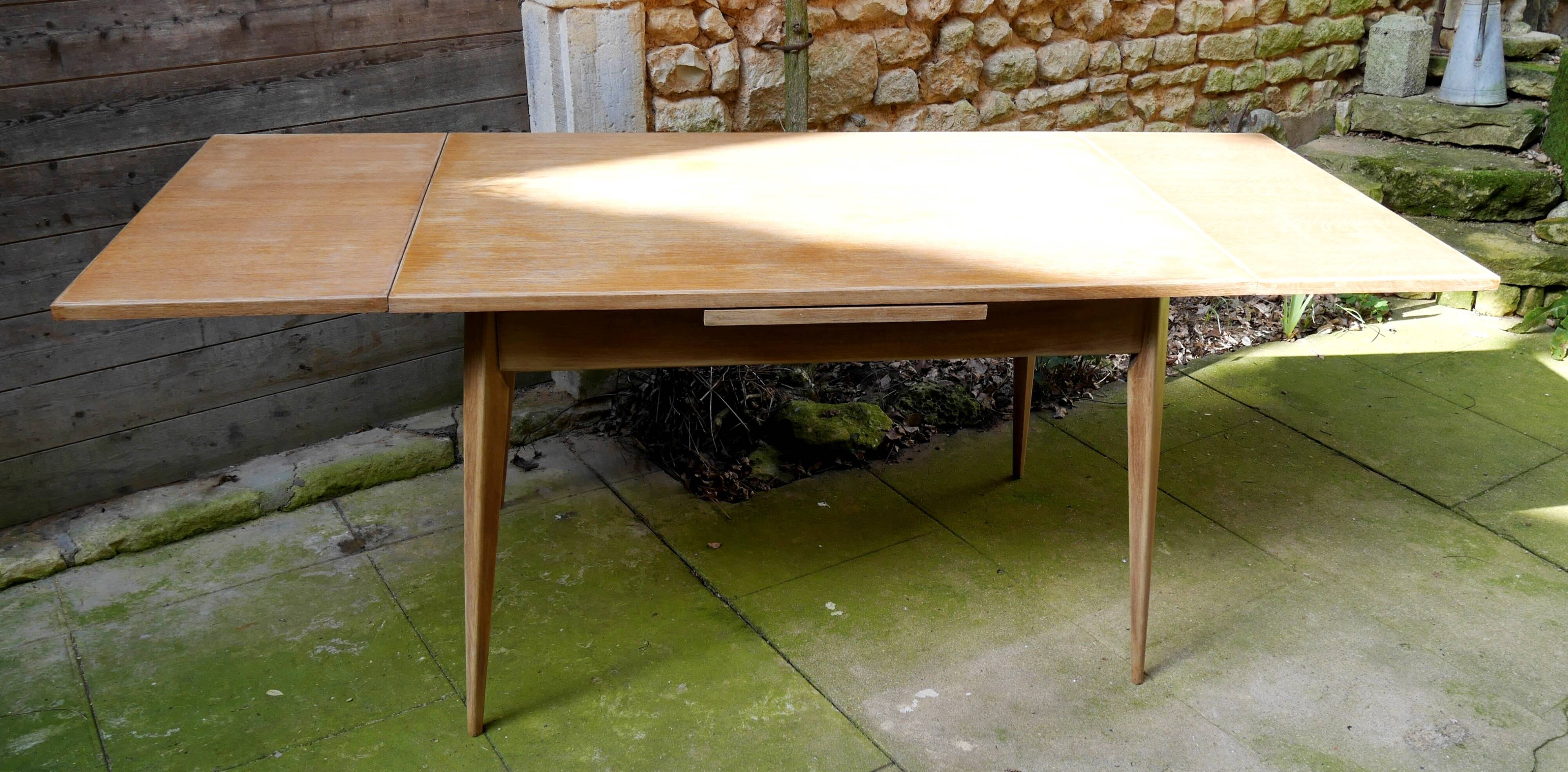 wooden dining table with compass legs and extensions