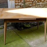 wooden dining table with compass legs and extensions