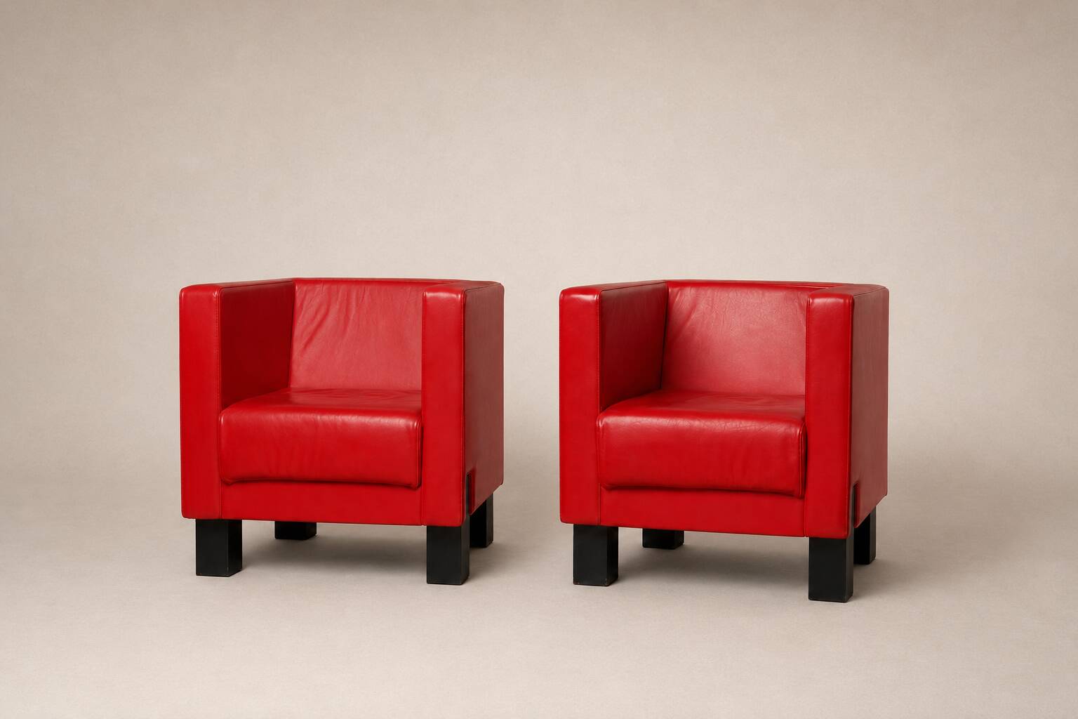 Uchida x Poltrona Frau — Pair of "Moji" armchairs in red leather