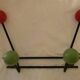 Small wrought iron coat rack with wooden balls.