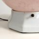 Art Deco lamp with a speckled pink glass globe and a white ceramic base.