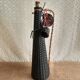 Glass bottle covered with black scoubidou with twisted golden handle - vintage