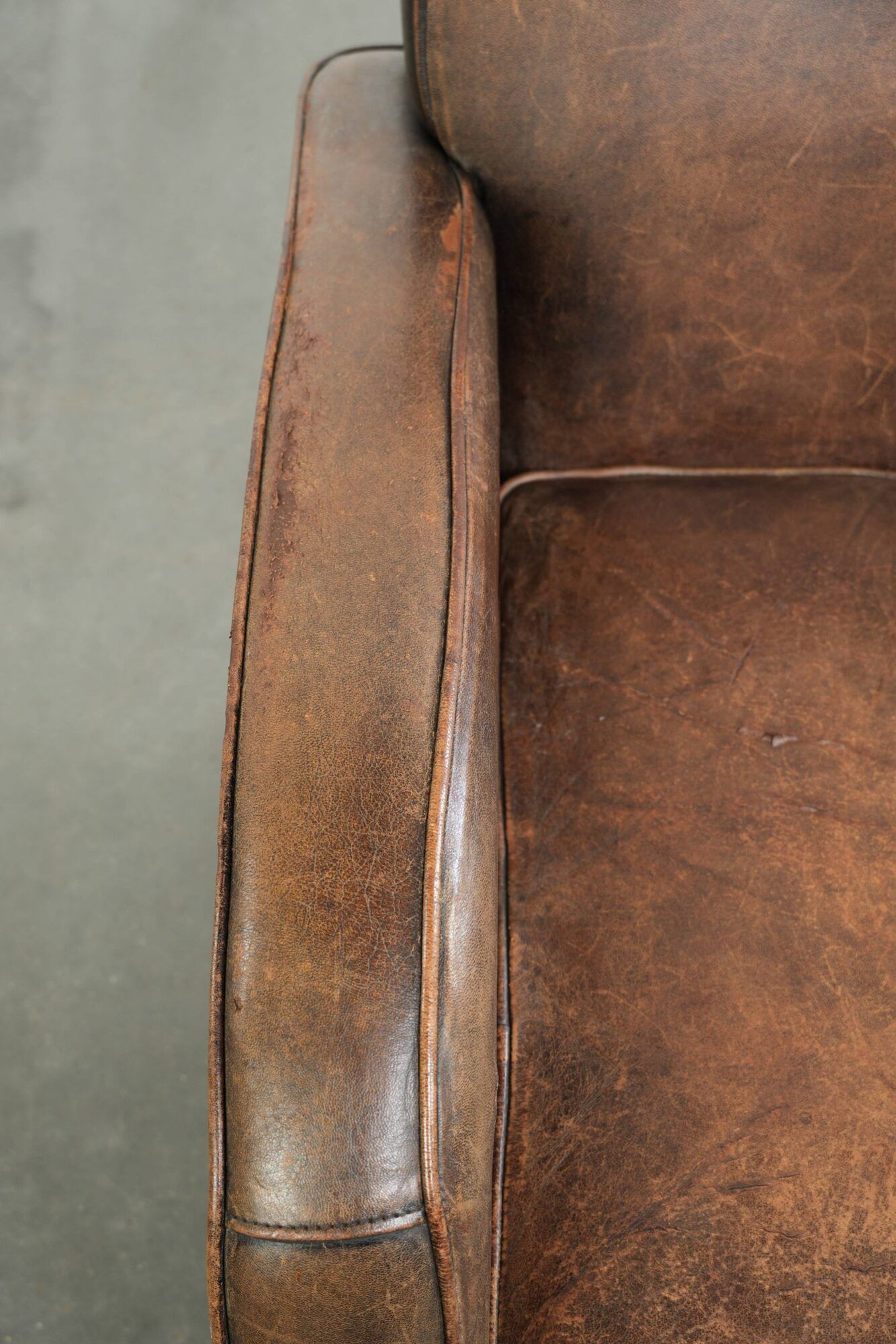 Comfortable sheepskin armchair with matching piping and a timeless look