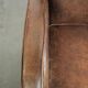 Comfortable sheepskin armchair with matching piping and a timeless look