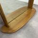 Miroir à tablette cerclage bois, forme ogive, années 60